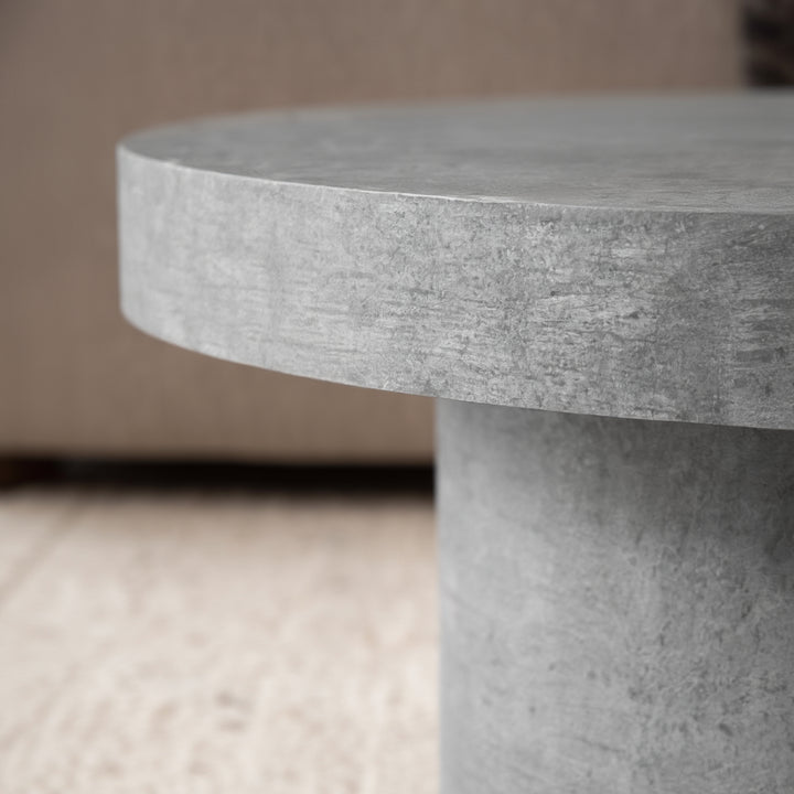 Struktur der Stein-Optik Oberfläche des runden Couchtischs auf hellen Teppichboden _