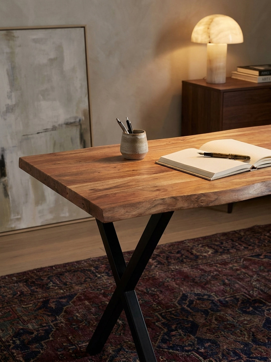 Einrichtungsidee für das Arbeitszimmer: Auf dem massiven Akazien-Schreibtisch liegt ein aufgeschlagenes Buch, daneben ein Tablet zur Inspiration._