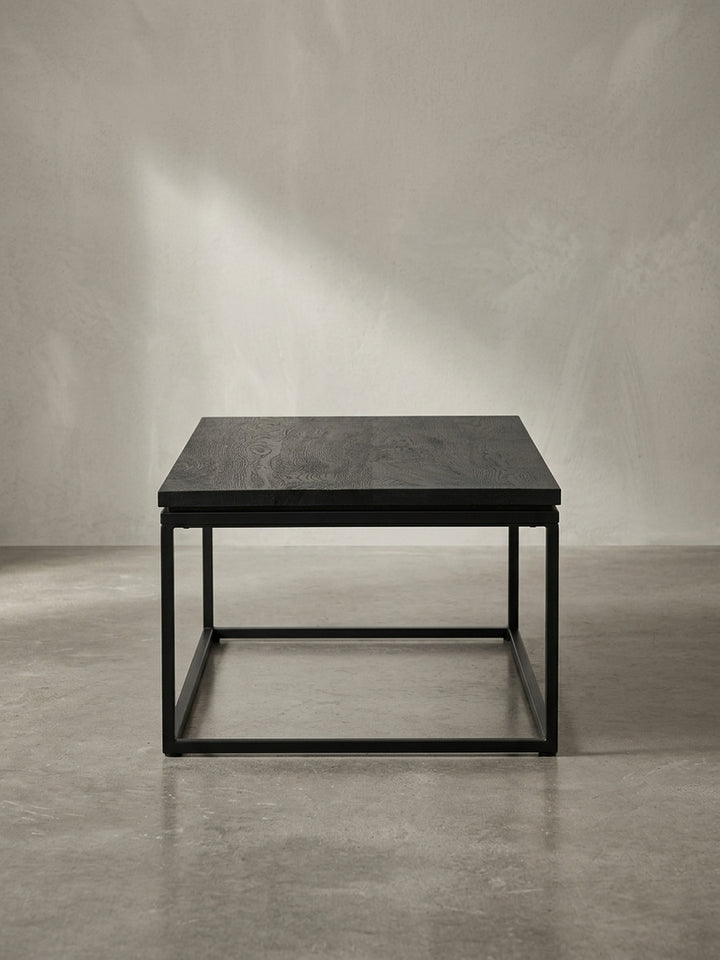 Gesamtüberblick des rechteckigen Couchtisches, der das moderne Zusammenspiel von natürlicher Holzmaserung und industriellem Metalldesign darstellt._