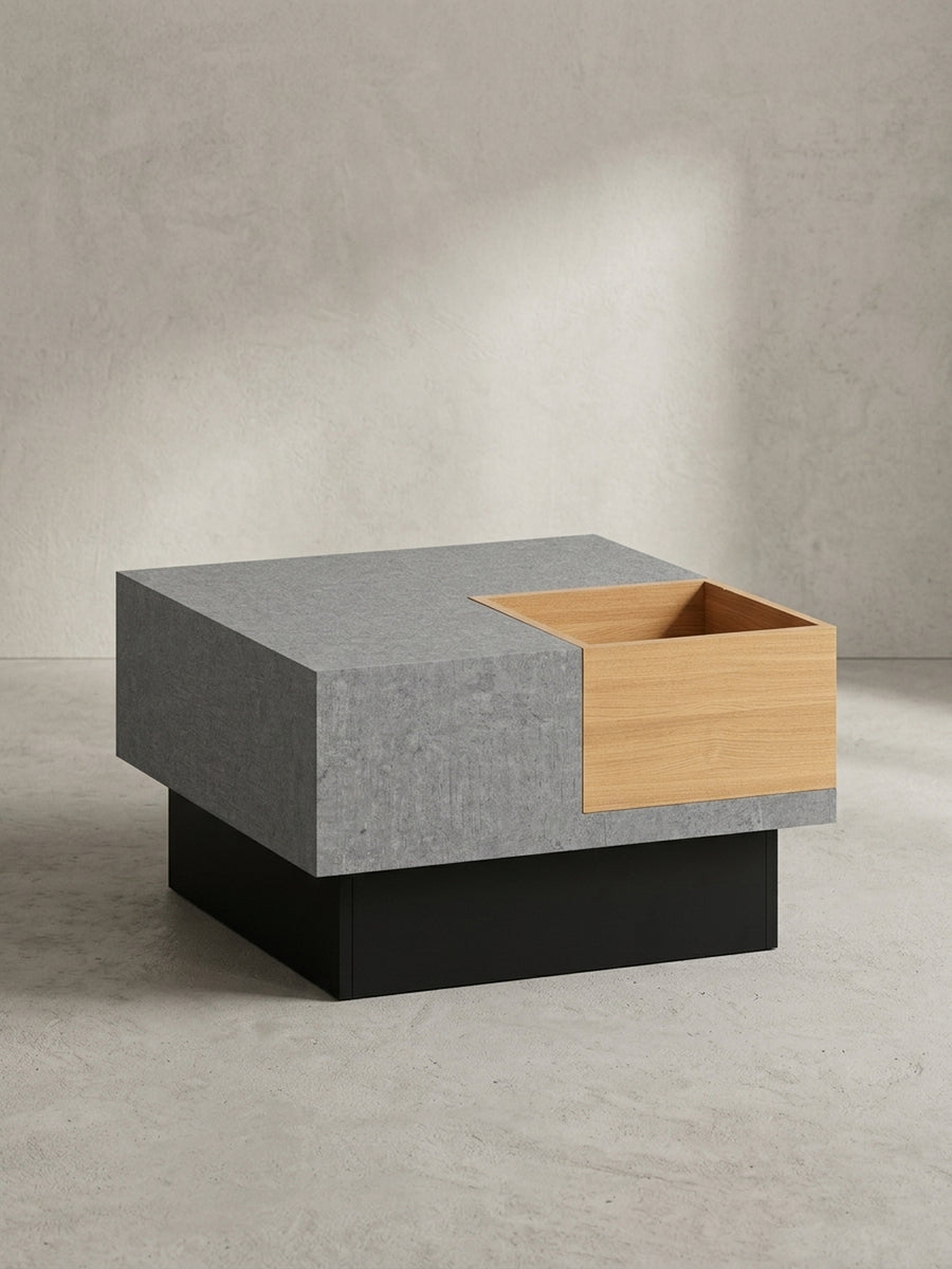 Geometrischer Kaffeetisch aus MDF mit Holz-Dekor und grauer Oberfläche im Dreiviertelprofil, der die kubische Form und den asymmetrischen Aufbau verdeutlicht._