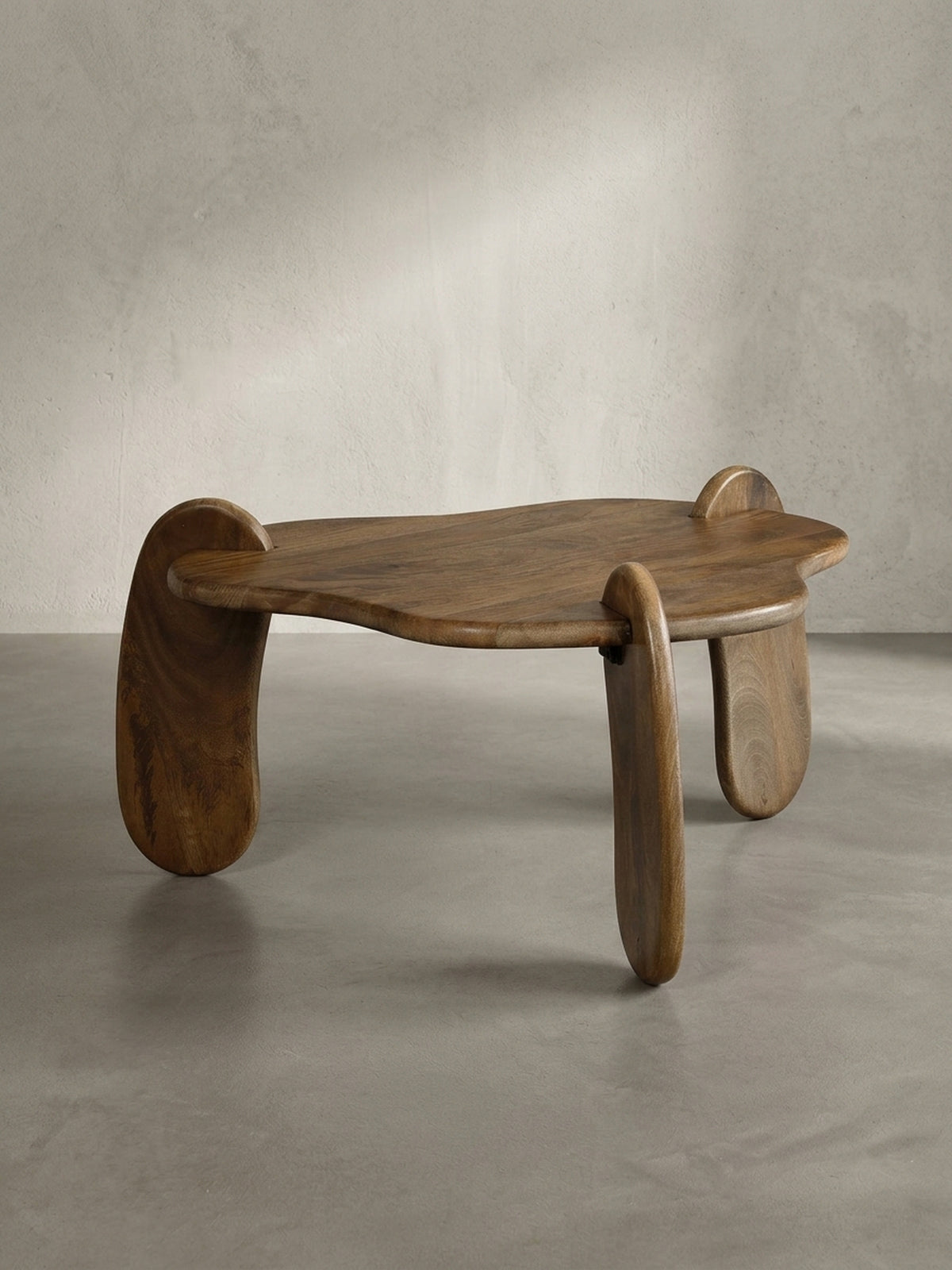 Seitenprofil des niedrigen Couchtisches aus Massivholz, das seine elegante, bodennahe Statur und die geschwungene Form der Beine hervorhebt._