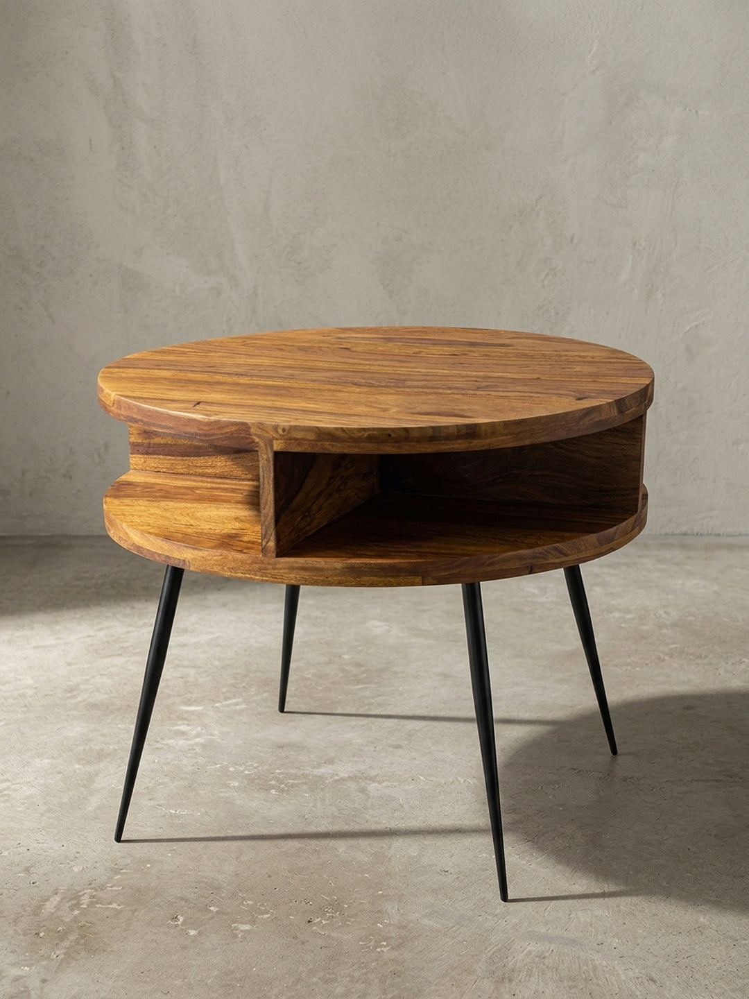Handgefertigter Couchtisch rund 60x45cm aus massivem Sheesham-Holz mit schwarzen Metallbeinen. Offene Ablage unter der Holzplatte im modernen Retro-Stil, Frontansicht._