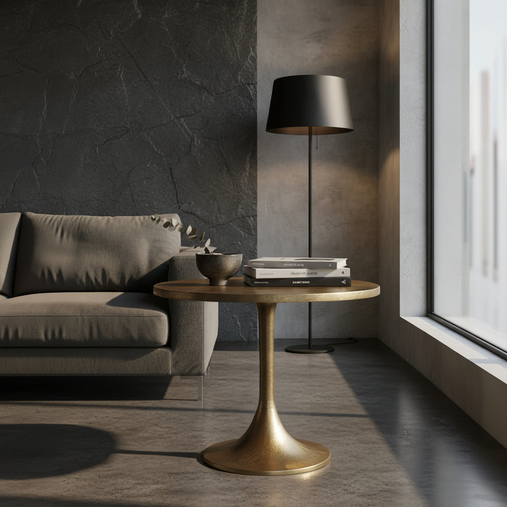 Eleganter goldfarbener Beistelltisch aus Aluminium neben grauem Sofa im modernen Wohnzimmer mit Stehlampe 