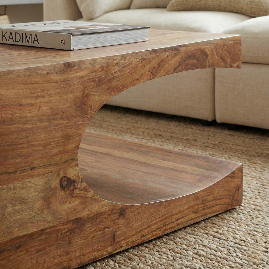 Massivholz-Couchtisch TEKO in Beige mit geschwungener Öffnung und Ablagefach, Nahaufnahme der Holzstruktur.