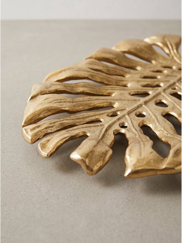 Florale Dekoschale aus Aluminium in strahlendem Gold als perfektes Einzelstück für den Wohnbereich auf weißem Grund_