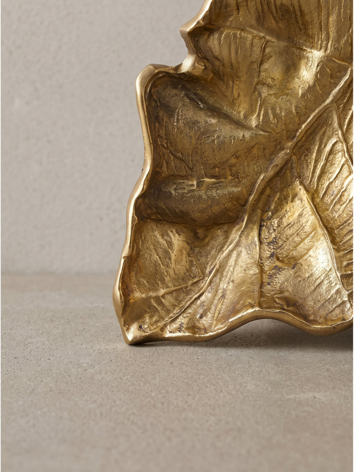 Die 67 cm breite goldene Blattschale zeigt sanfte Unebenheiten, die den authentischen Manufaktur-Charakter des Objektes unterstreichen._
