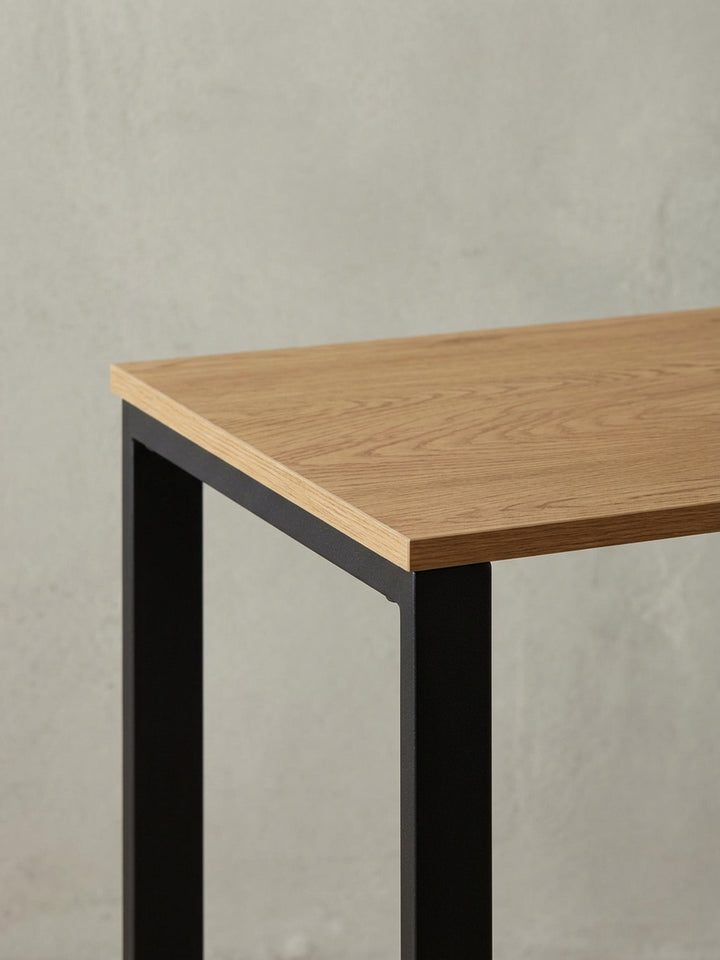 Industrie-Design Schreibtisch aus einer alternativen Perspektive, die das Zusammenspiel von heller Holzoptik und dunklem Metall betont._