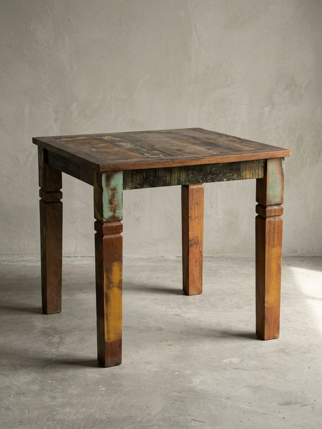 Massiver Esstisch 80x80x76 cm im Frontalprofil. Der quadratische Landhaus Holztisch aus recyceltem Mangoholz besticht durch markante Beine und eine bunte Vintage Lackierung._