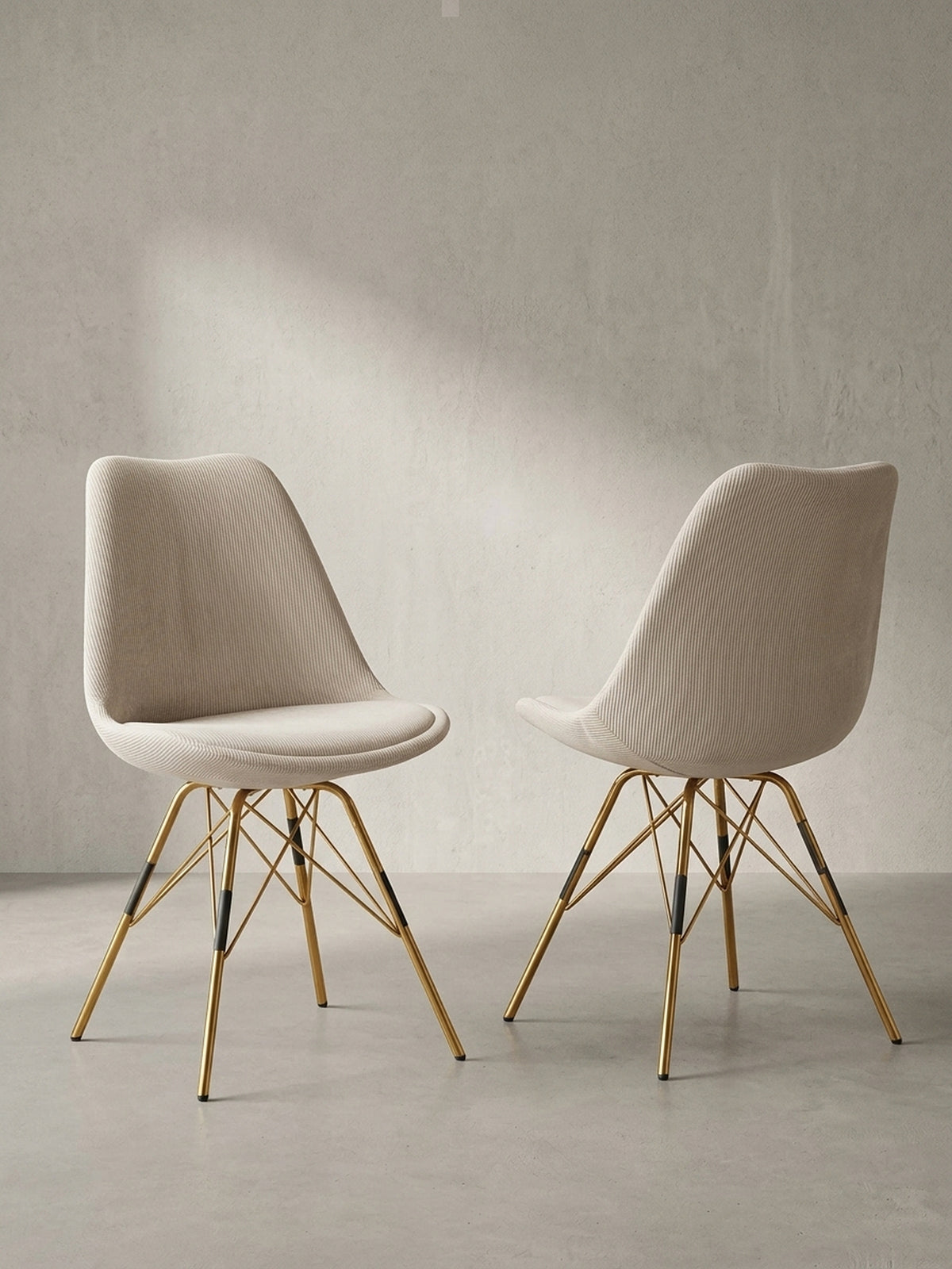 Halbprofil eines beigen Küchenstuhls aus Cordstoff zur Veranschaulichung der ergonomischen Schalenform und des überkreuzten Metallgestells_
