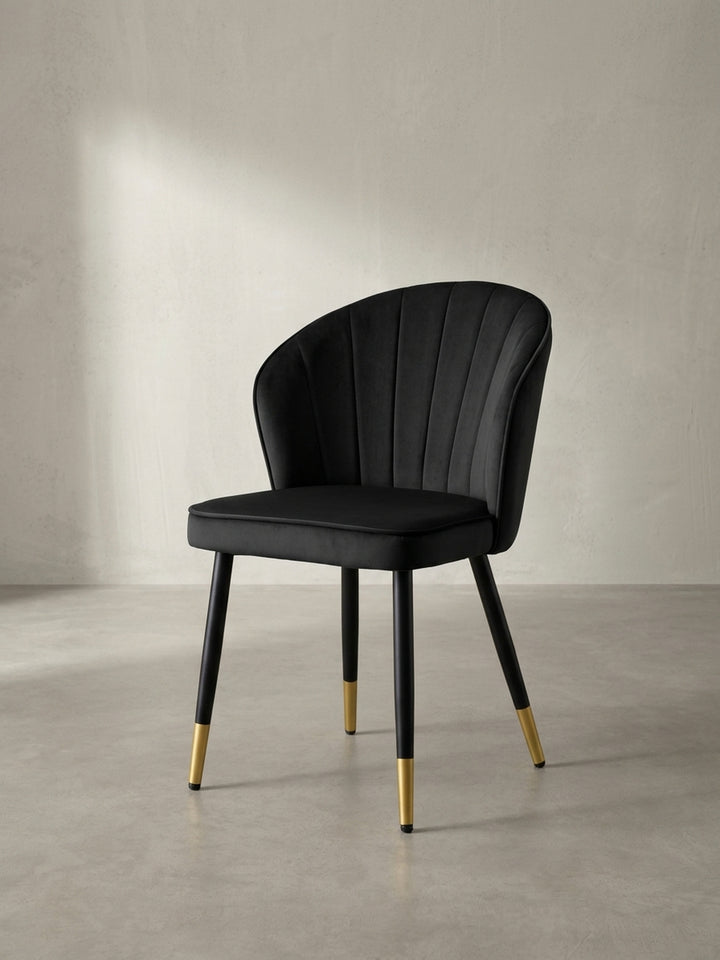 Schräge Seitenansicht des skandinavisch inspirierten Schalenstuhls in Schwarz, der die geschwungene ergonomische Form der weichen Rückenlehne perfekt zeigt._