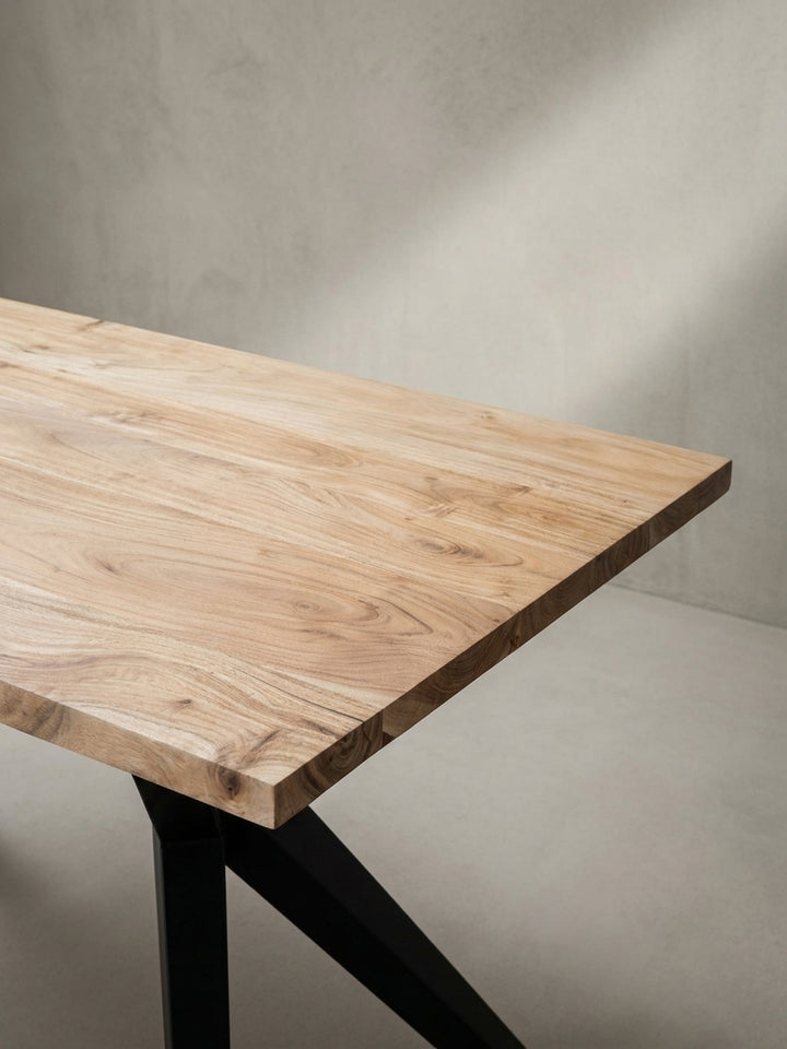 Dynamische Perspektive auf den Esszimmertisch, die die Tiefe des Designs und die handwerkliche Qualität des Akazienholzes unterstreicht._