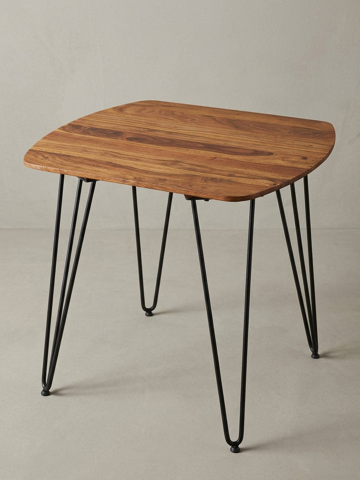 Alternative Perspektive des kompakten Echtholz-Tisches für Esszimmer oder Küche. Die warme braune Holzoberfläche spiegelt modernes Design und hochwertige Naturmaterialien wider._