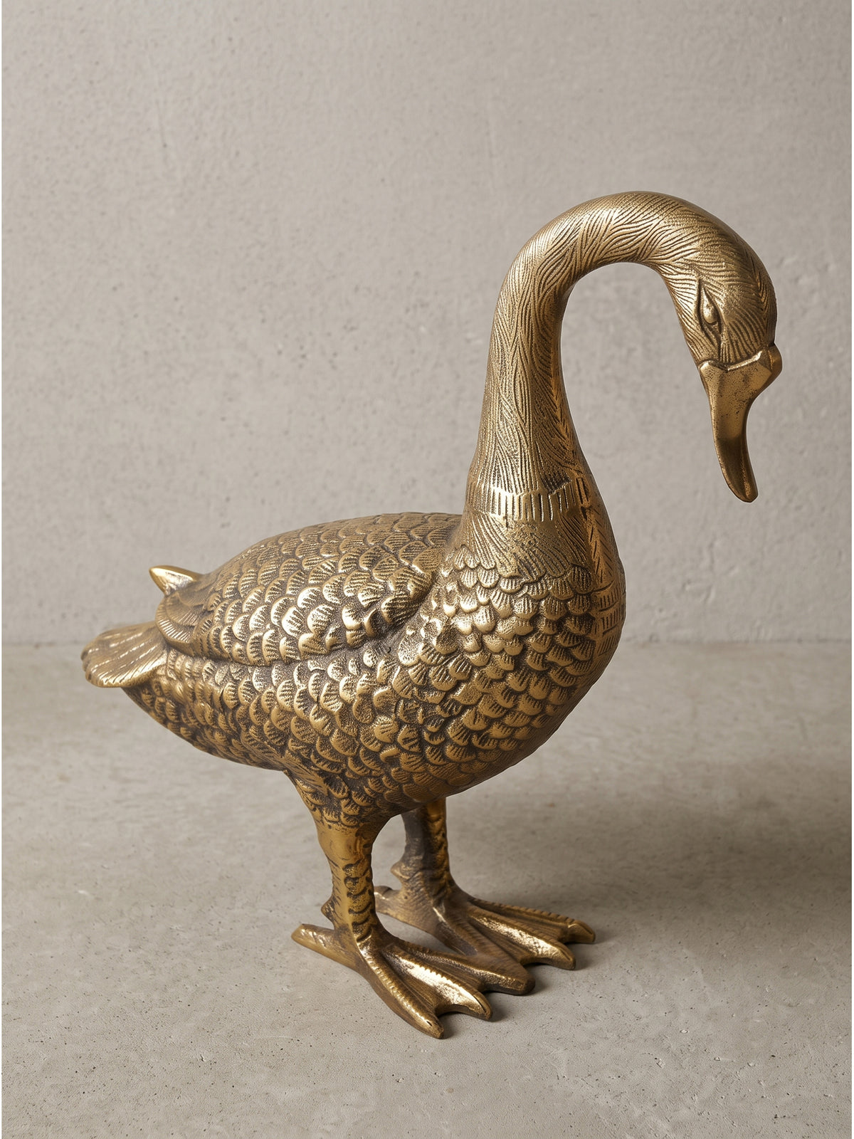 Nahaufnahme des Kopfes der goldenen Deko-Gans aus Aluminium, die charakteristische Schnabelform und die fein texturierte Oberfläche spiegeln den beeindruckend hohen handwerklichen Detailgrad wider._