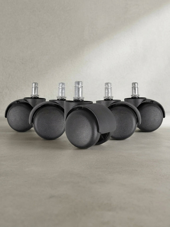 Frontale Ansicht des 5er Sets Weichbodenrollen in Schwarz, ideal für Teppichböden im heimischen Arbeitszimmer._