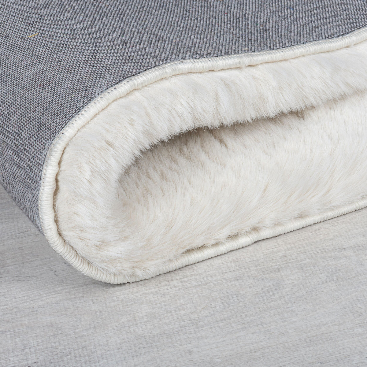 Teppich Kunstfell Creme-Weiß uni Hochflor Rückseite Kante Detail weich Rechteckig