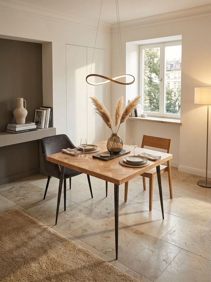 Draufsicht auf den kleinen quadratischen Esszimmertisch aus Holz. Das kunstvolle Fischgrätmuster der 80x80cm großen Akazienholz-Tischplatte wird im stilvollen Raum perfekt inszeniert._