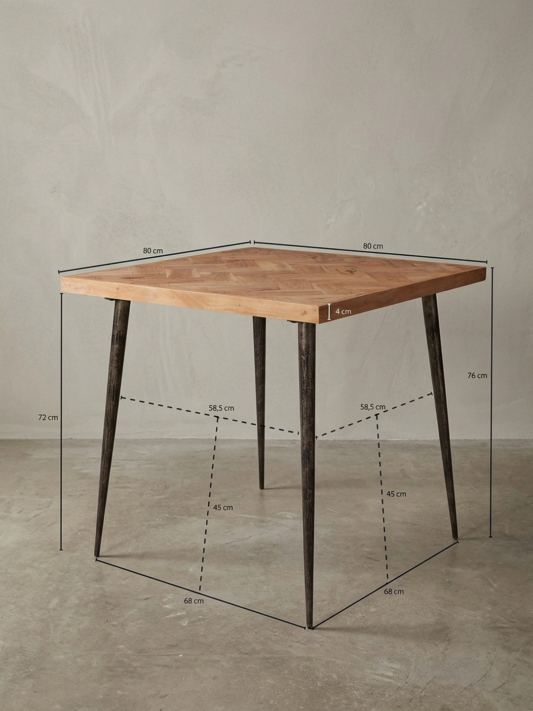 Rückseitige Detailansicht der Tischkonstruktion. Die Verschraubung der pulverbeschichteten Eisenbeine an der massiven Akazienholzplatte des kleinen Esstisches garantiert Langlebigkeit._