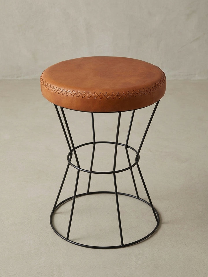 Dekohocker aus Echtleder und Metall aus einer leicht erhöhten Perspektive, ideal als flexible Sitzgelegenheit oder Beistelltisch für Flur oder Schlafzimmer._