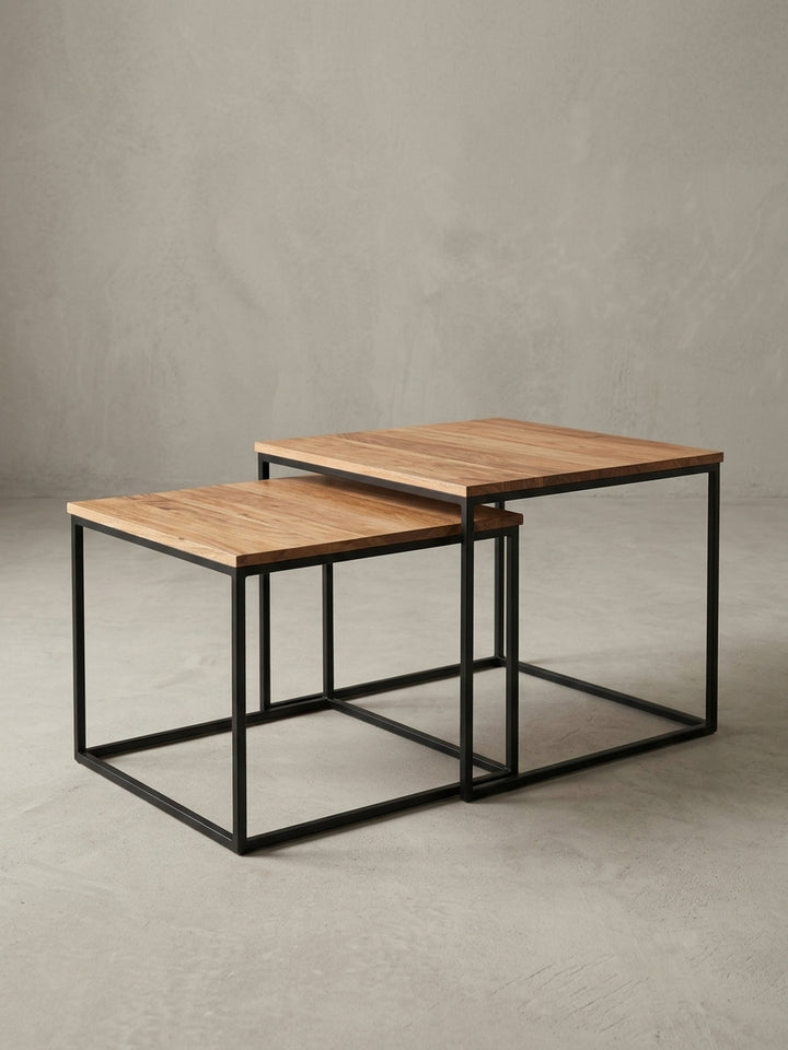 Seitenansicht des Beistelltisch-Sets, die das filigrane schwarze Metallgestell und die Proportionen der massiven Holzplatten deutlich macht._