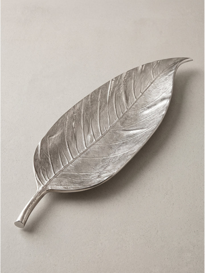 Silberne Metallschale im Blatt-Design schräg von der linken Seite betrachtet mit glänzender Oberfläche_