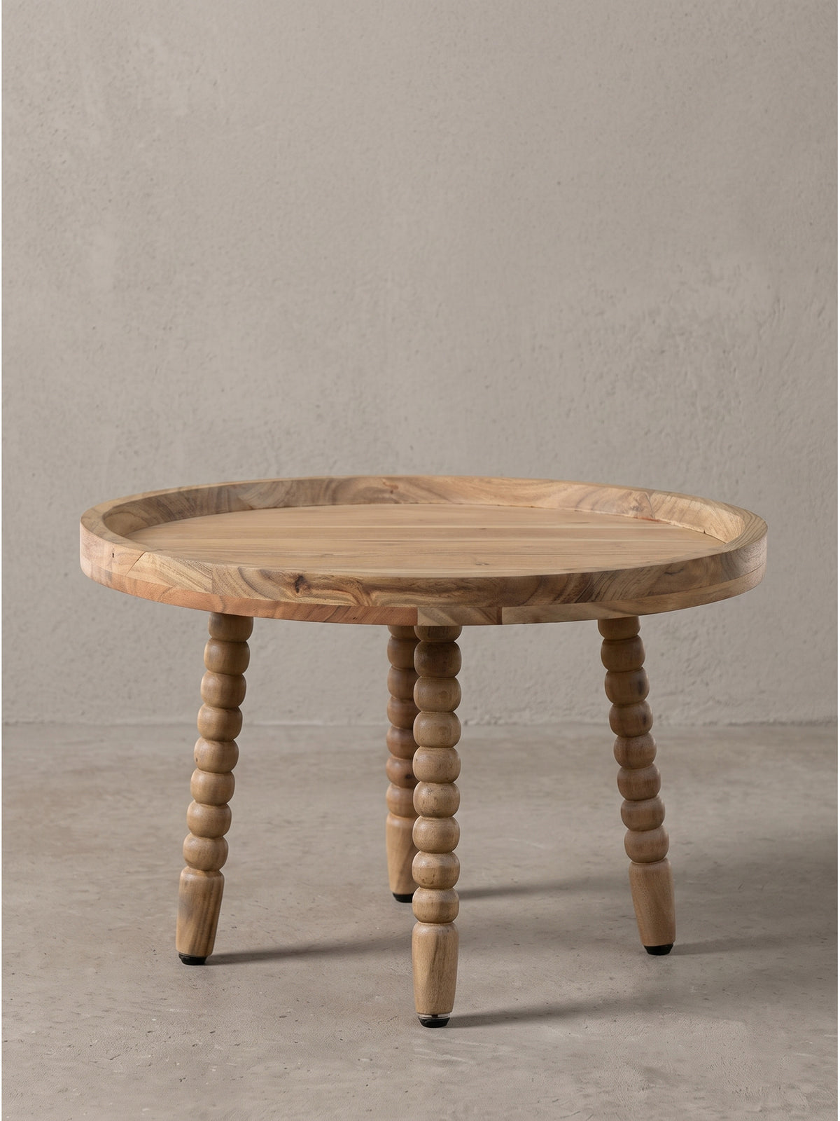 Runder Couchtisch Akazie Massivholz 60x60x40 cm mit markantem Tablettrand und vier verzierten Beinen frontal freigestellt_