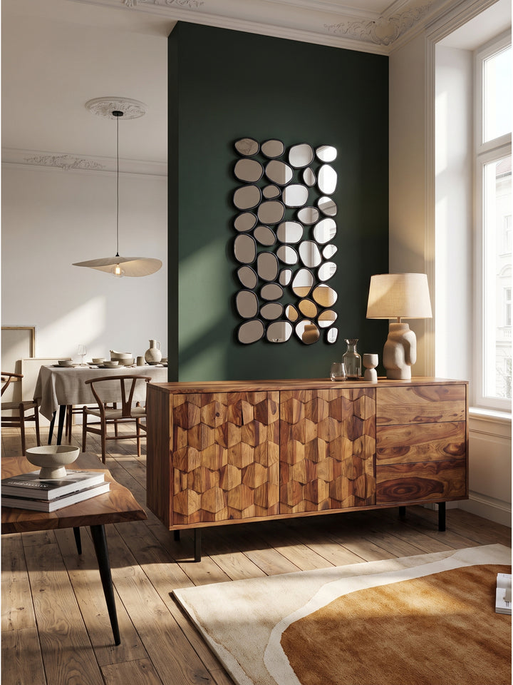Das Industrial Style Sideboard aus massivem Holz harmoniert perfekt mit einem großen runden Spiegel und dunklen Akzenten im modernen Esszimmer._