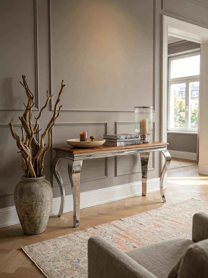 Luxuriöser Konsolentisch aus Sheesham Massivholz im eleganten Flur. Der 130x42 cm breite Flurtisch mit geschwungenen Edelstahlbeinen im Barockstil prägt das stilvolle Entrée._