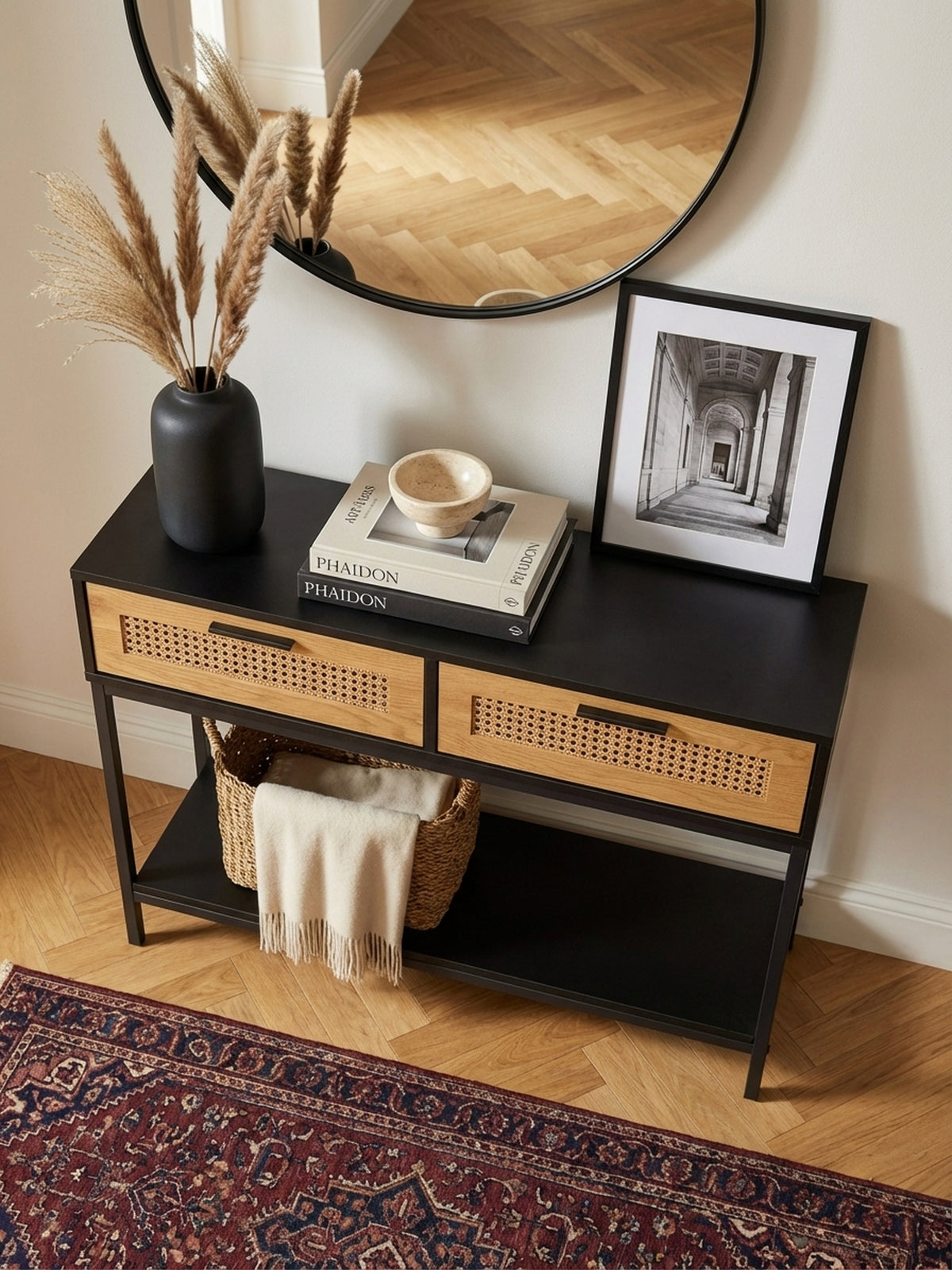 Draufsicht auf den schmalen Dielentisch mit Rattanschubladen, dekoriert mit Lampe und Vase, in einem modernen Eingangsbereich._