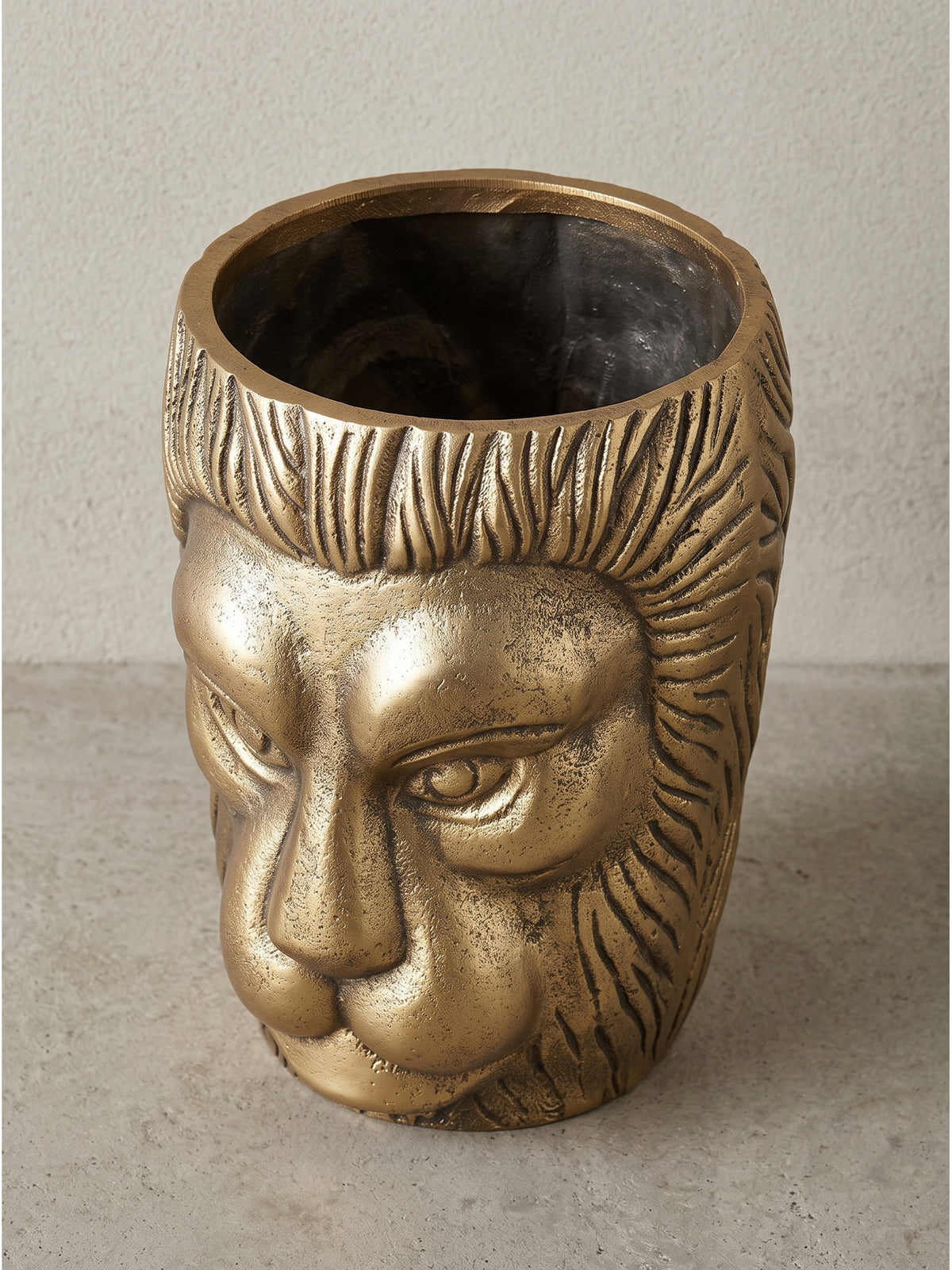 Leicht angewinkelte Ansicht der handgefertigten goldenen Alu-Vase, freigestellt vor hellem Studiohintergrund.