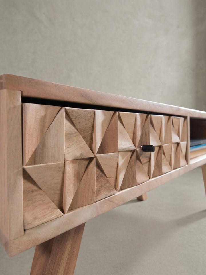 Fokus auf den dezenten, schwarzen Metallgriff an der aufwendig gefrästen Schublade des Akazien-Couchtisches. Die präzise Verarbeitung des Massivholzes unterstreicht das Design._