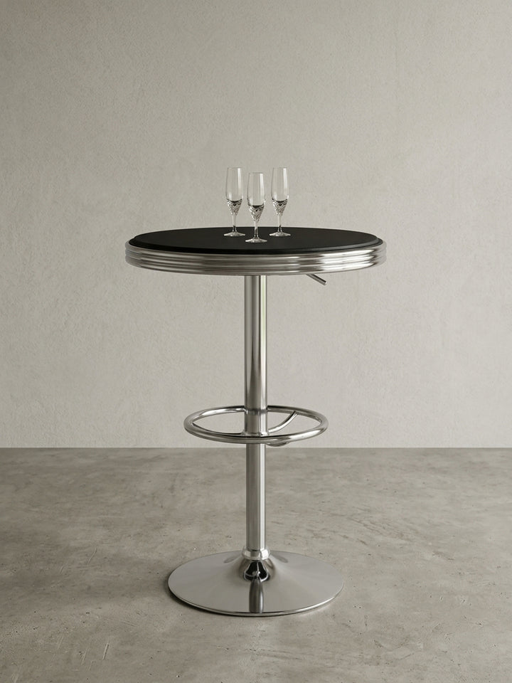 Runder Bartisch im 50er Jahre Retro-Design freigestellt. Die schwarze Kunstleder-Tischplatte und das glänzende Aluminium-Trompetengestell bilden einen starken Kontrast in Silber-Schwarz._