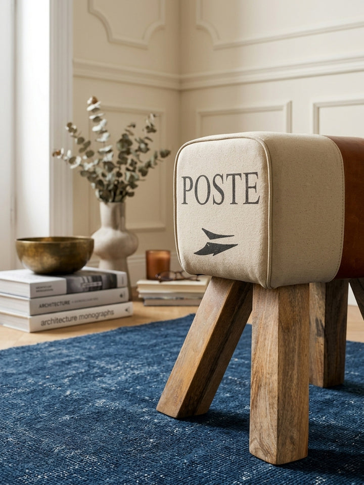 Nahaufnahme der Materialkombination: Robustes beiges Baumwollgewebe trifft auf weiches, echtes Leder, ergänzt durch präzise Nähte am 40x30 cm großen, luxuriösen Fußhocker._