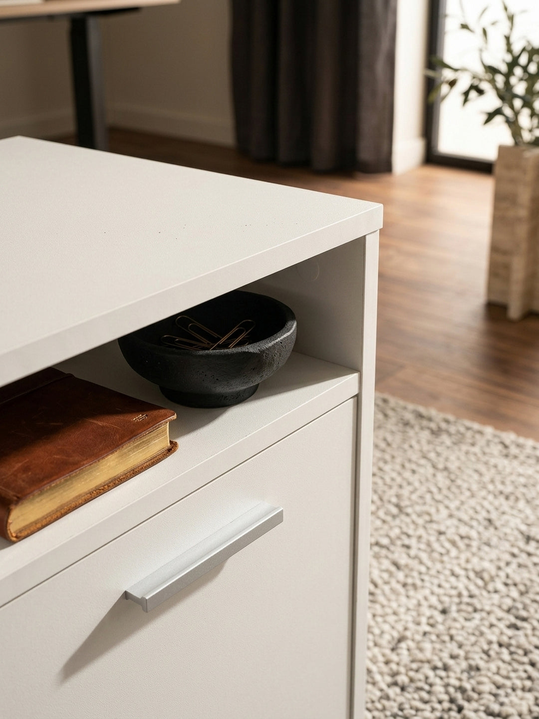 Detailaufnahme der pflegeleichten, weißen Melaminharzbeschichtung des Schreibtisch-Containers. Die feine, matte Oberflächenstruktur ist ideal für den täglichen Gebrauch im Home Office._