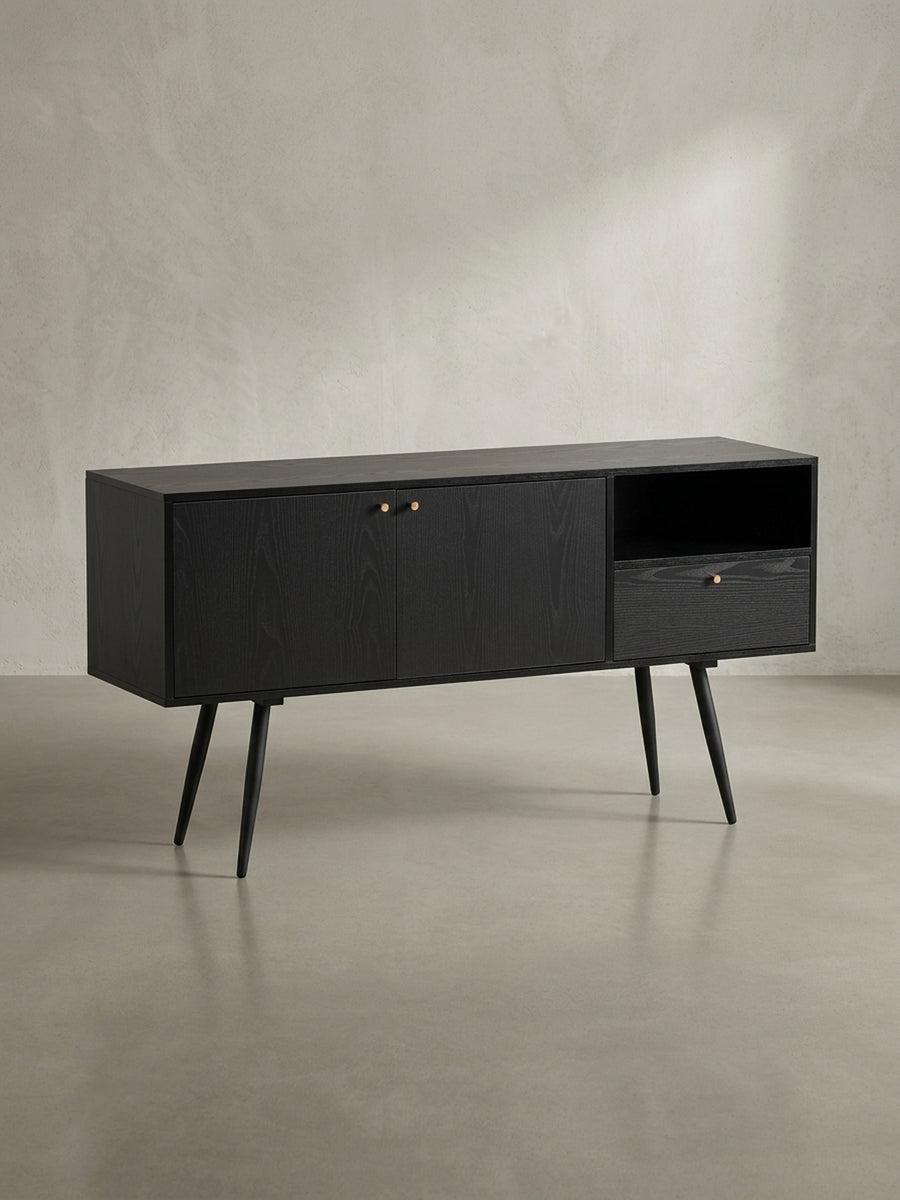 Gesamtübersicht des zeitlosen Sideboards mit schwarzem Eiche-Dekor, das durch seine asymmetrische Aufteilung und mid-century inspirierte Beine besticht._