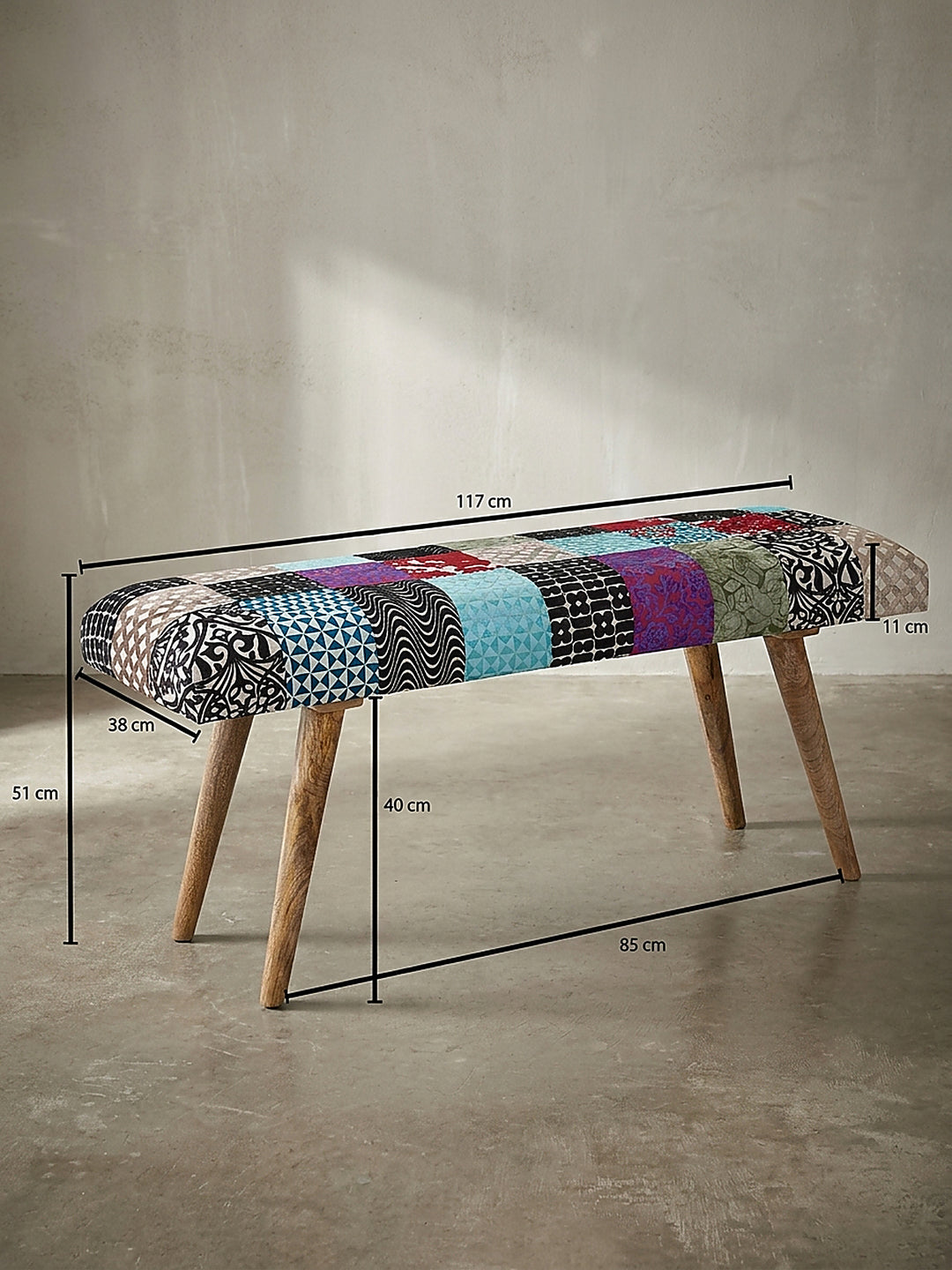 Technische Zeichnung der bunten Patchwork-Bank mit genauen Maßangaben von 117 cm Länge, 51 cm Höhe und 38 cm Breite zur perfekten Raumplanung._