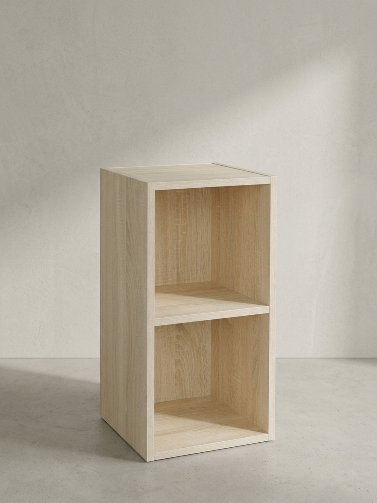 Leicht gedrehte Vorderansicht des kompakten Holzregals für schmale Nischen mit pflegeleichter und robuster Melamin-Oberfläche._