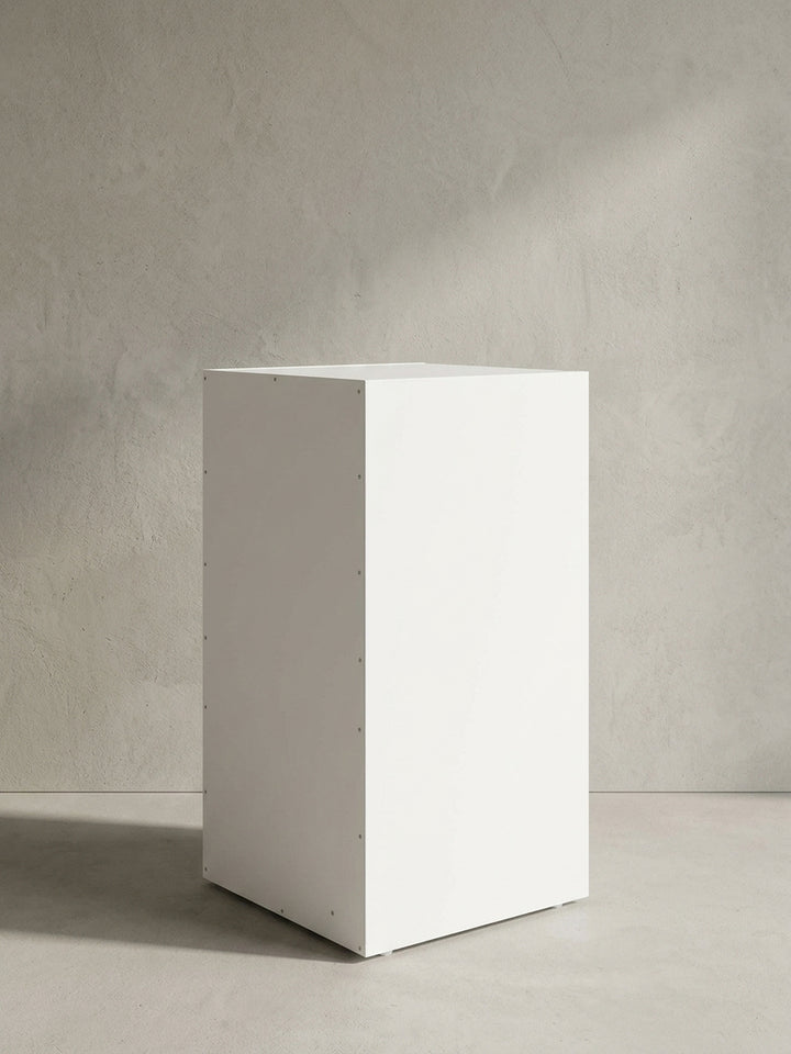 Schräge Detailansicht des minimalistischen Kleinmöbels, zeigt die saubere Kantenverarbeitung der weißen Ablagefächer._