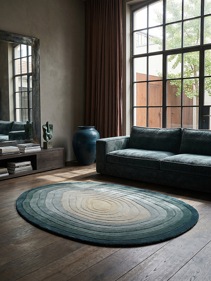 Teppich Türkis-Beige oval Editorial Interior als Designobjekt drapiert hochwertige Wohnaccessoires_