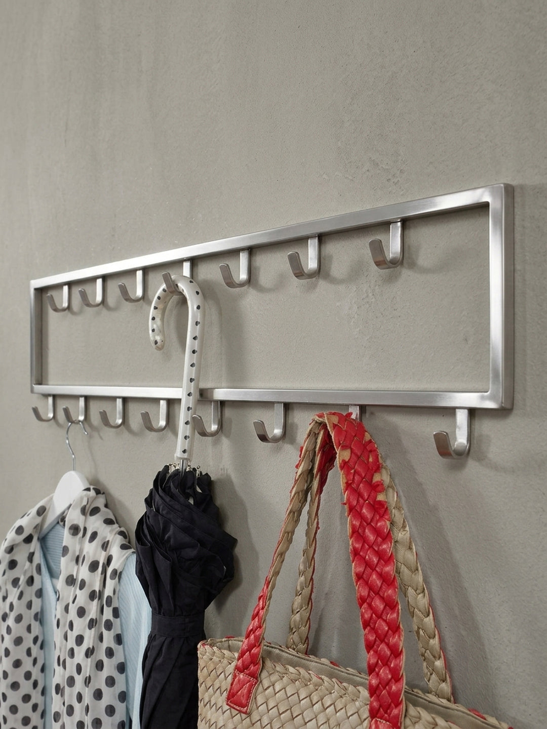 Alternative Perspektive auf die moderne Hakenleiste, die das Zusammenspiel der oberen und unteren Hakenreihe und das offene Rahmendesign betont._