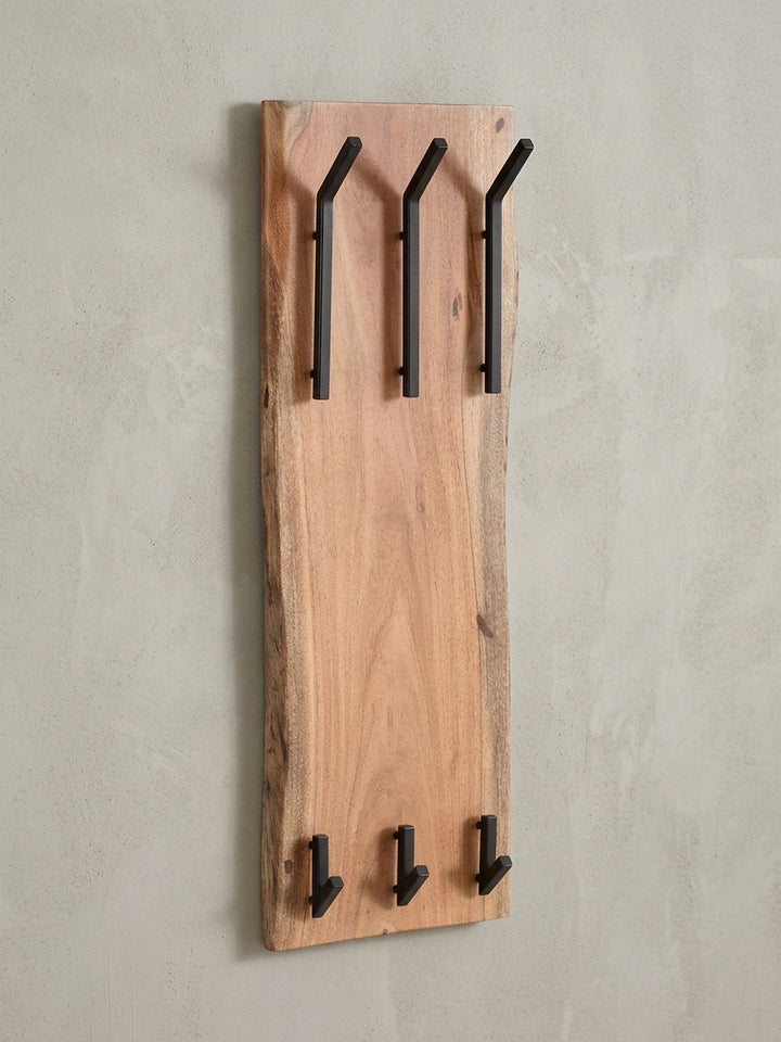 Komplette Übersicht der Wandgarderobe, die das harmonische Design aus natürlichem Akazien-Massivholz und industriellen schwarzen Metallhaken für einen modernen Flur darstellt._