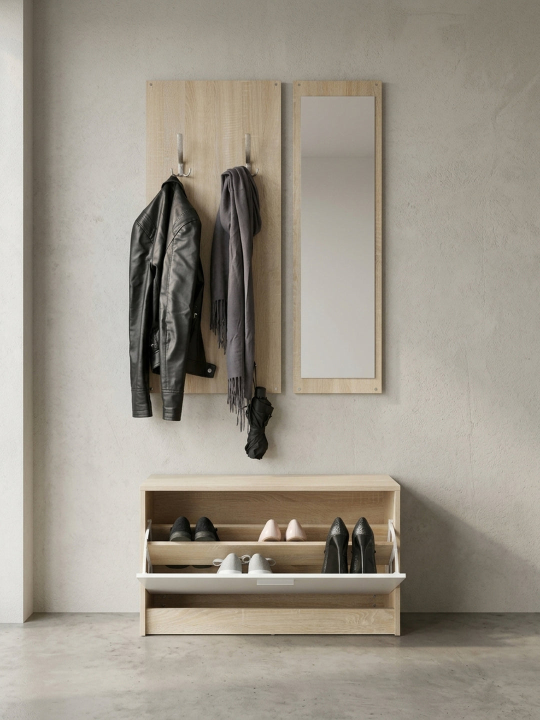 Seitenansicht der minimalistischen Garderobe. Der flache Schuhschrank für bis zu acht Paar Schuhe und die bündig an der Wand anliegenden Paneele verdeutlichen das platzsparende Design._