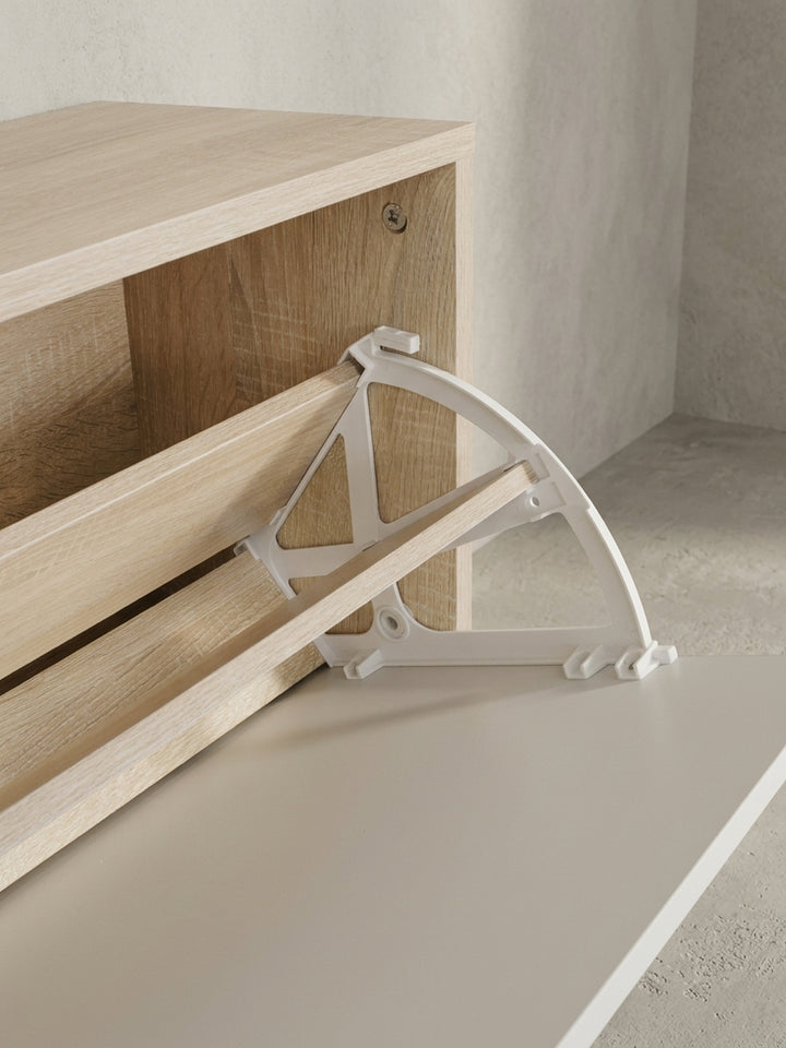 Nahaufnahme der eleganten Garderobenhaken. Die matt silbernen Haken aus lackiertem Metall heben sich dezent von der warmen Sonoma Eichenholz-Struktur des Wandpaneels ab._