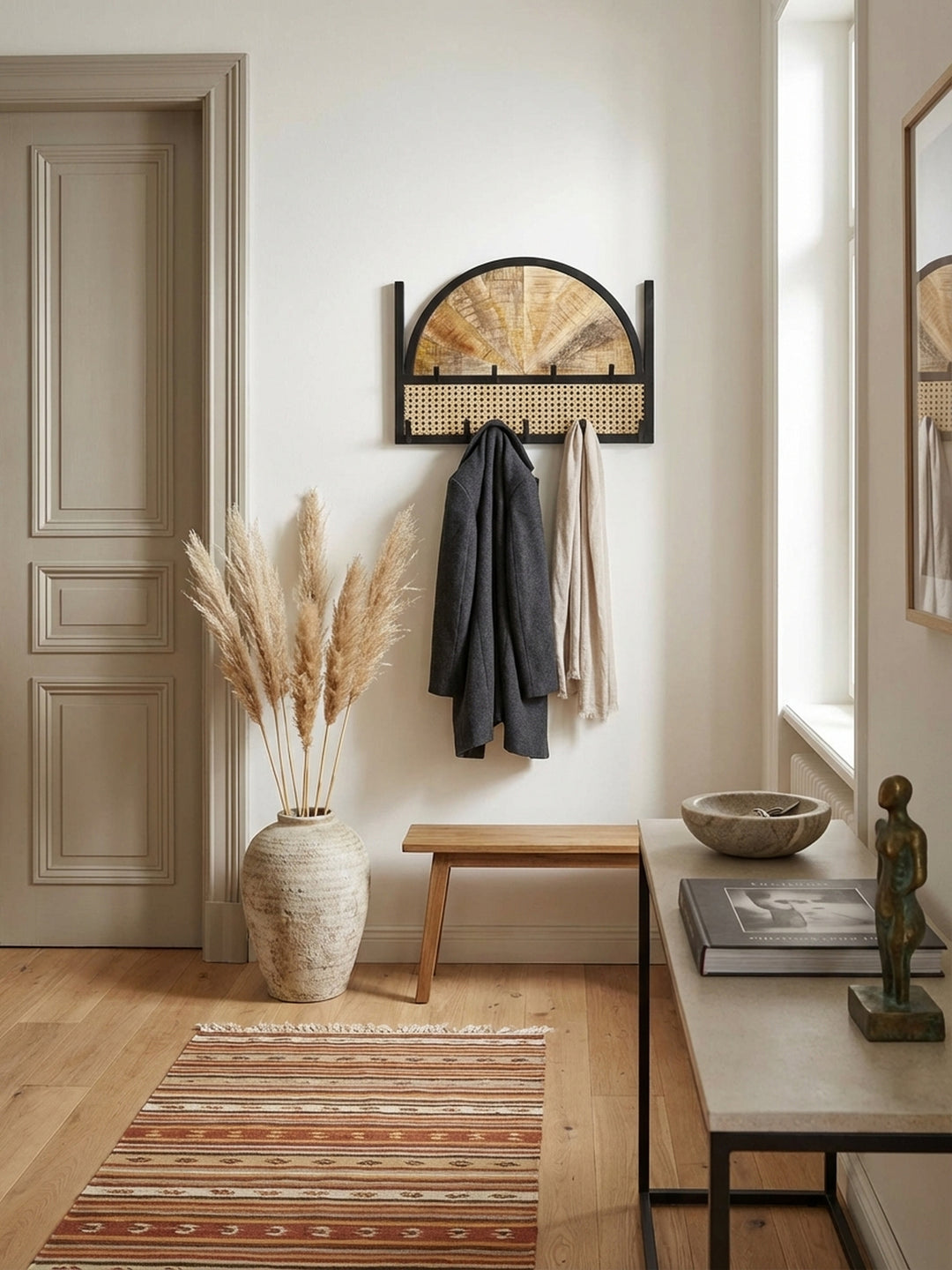 Blick von oben auf die Flurgarderobe mit Wiener Geflecht, die eine aufgeräumte und stilvolle Eingangssituation schafft._