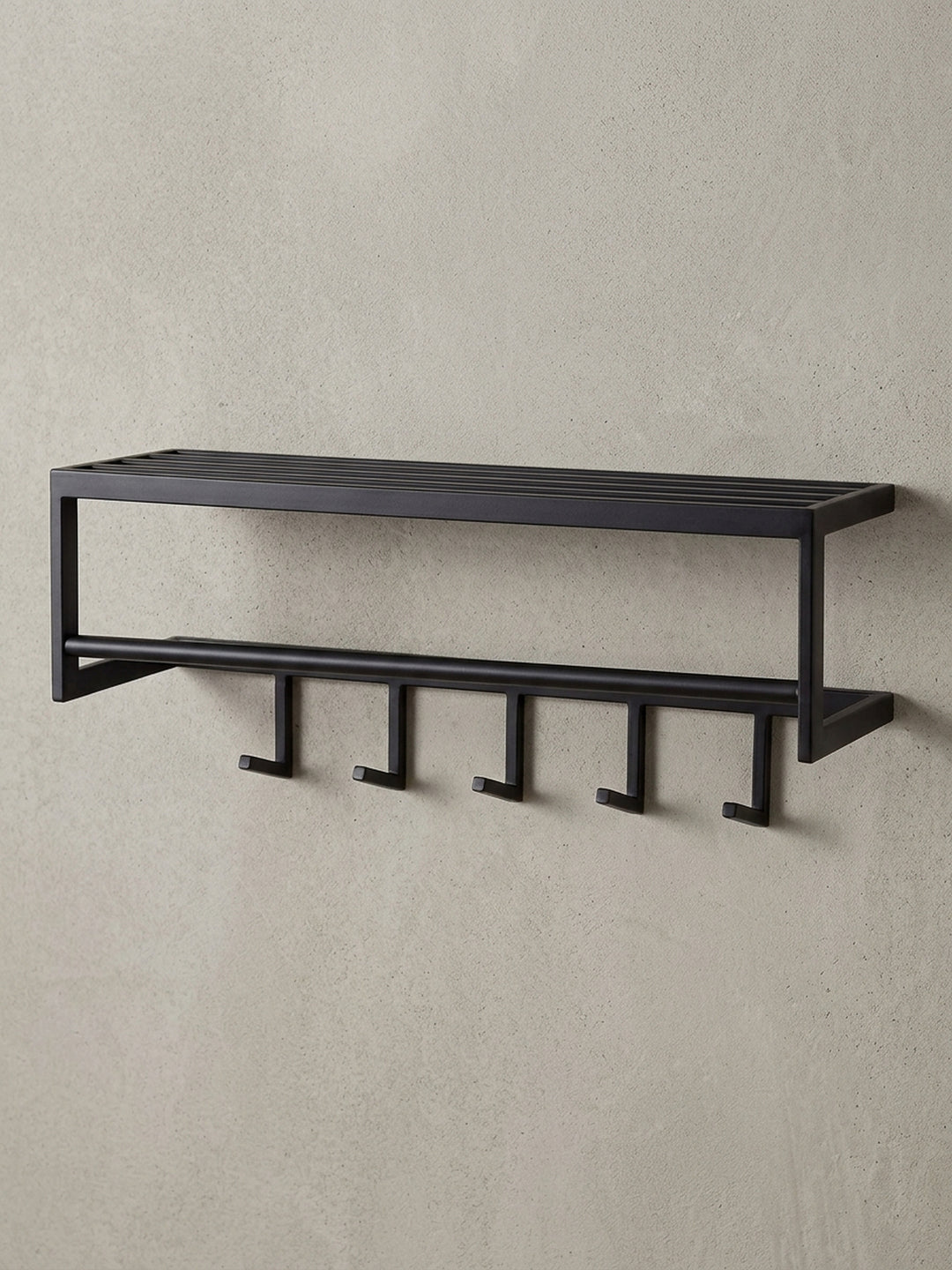 Schrägansicht der schwarzen Design-Hakenleiste aus Metall, die die räumliche Tiefe von 20 cm und die stabile Konstruktion des Wandpaneels verdeutlicht._