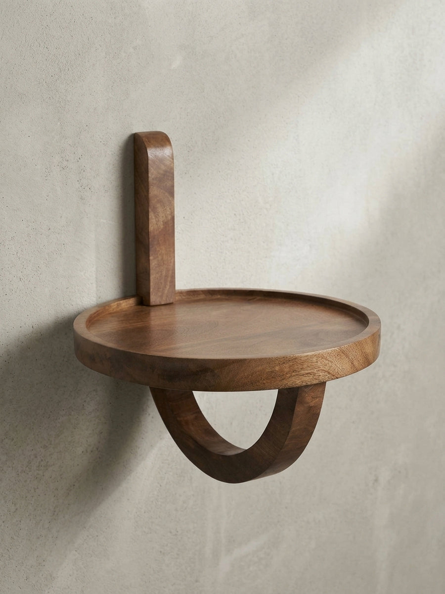 Freigestellte Frontansicht des runden Wandregals aus massivem Mangoholz mit seiner einzigartigen, geschwungenen Halterung._